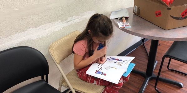 A little girl reading book.