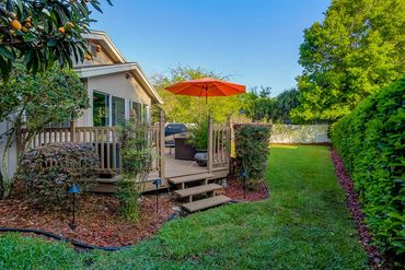 backyard with mulch beds, plants, hedges, and green sod