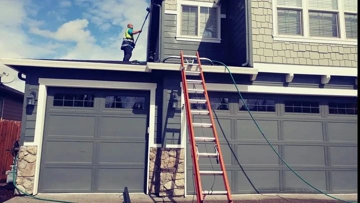 Pacific Diligent Services worker using an extension pole to perform exterior cleaning in Beaverton.