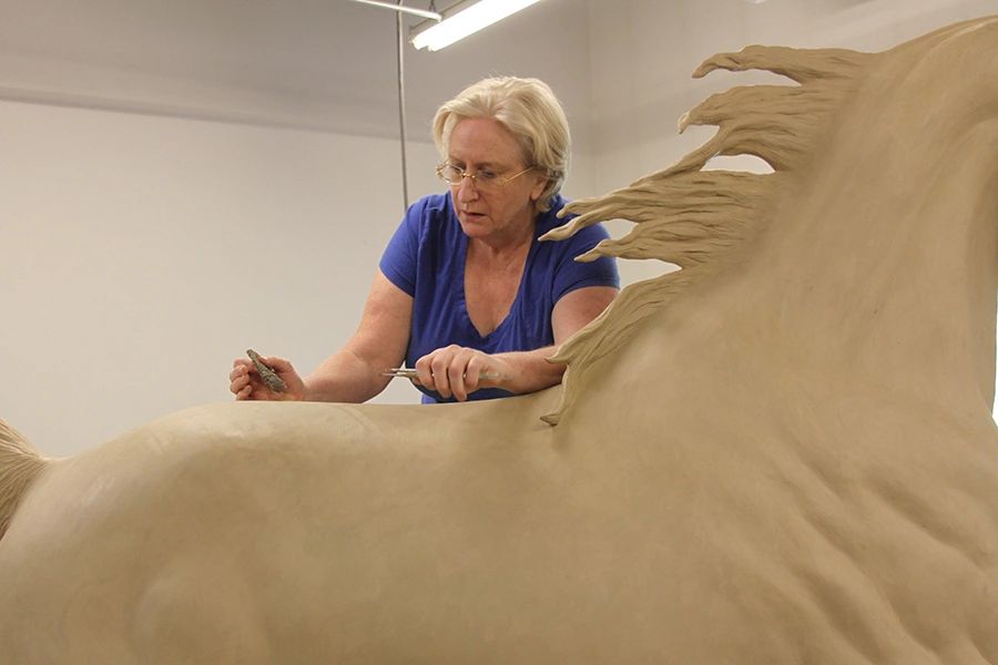 Bronze sculptor, J. Anne Butler hard at work on a life size Saddlebred horse bronze sculpture.
