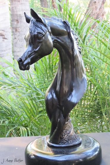 Oasis bronze sculpture in black patina on rotating black granite base.