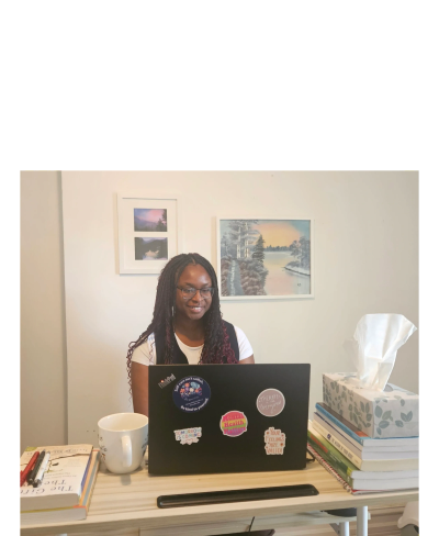 Woman working on a laptop with mental health stickers
