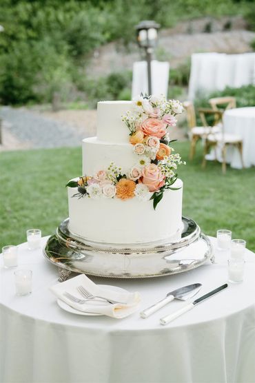 Wedding Cake with peach, orange, white and light blush flowers. 