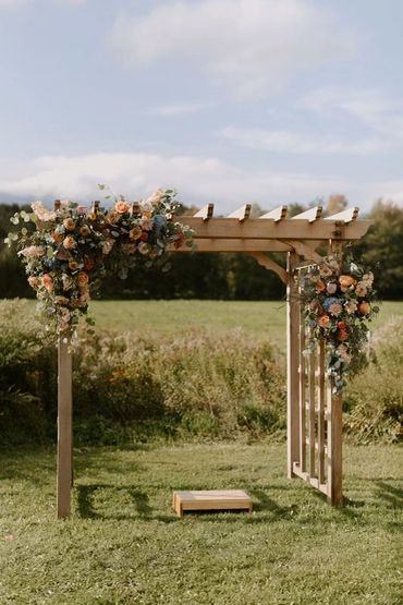 Fall wedding arbor flowers. Fall wedding at Topnotch Stowe, Vermont
Photo Credit: The Light + Color