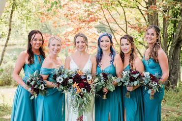A group of bridesmaids with fall flower bouquets. Photo Credit: Maple Leaf Photography