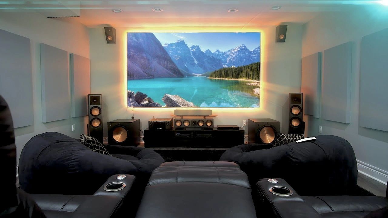 TV wall mounted with led lights. Home theater with audio video setup.