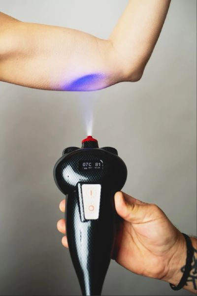 Handheld device emitting light on an arm.