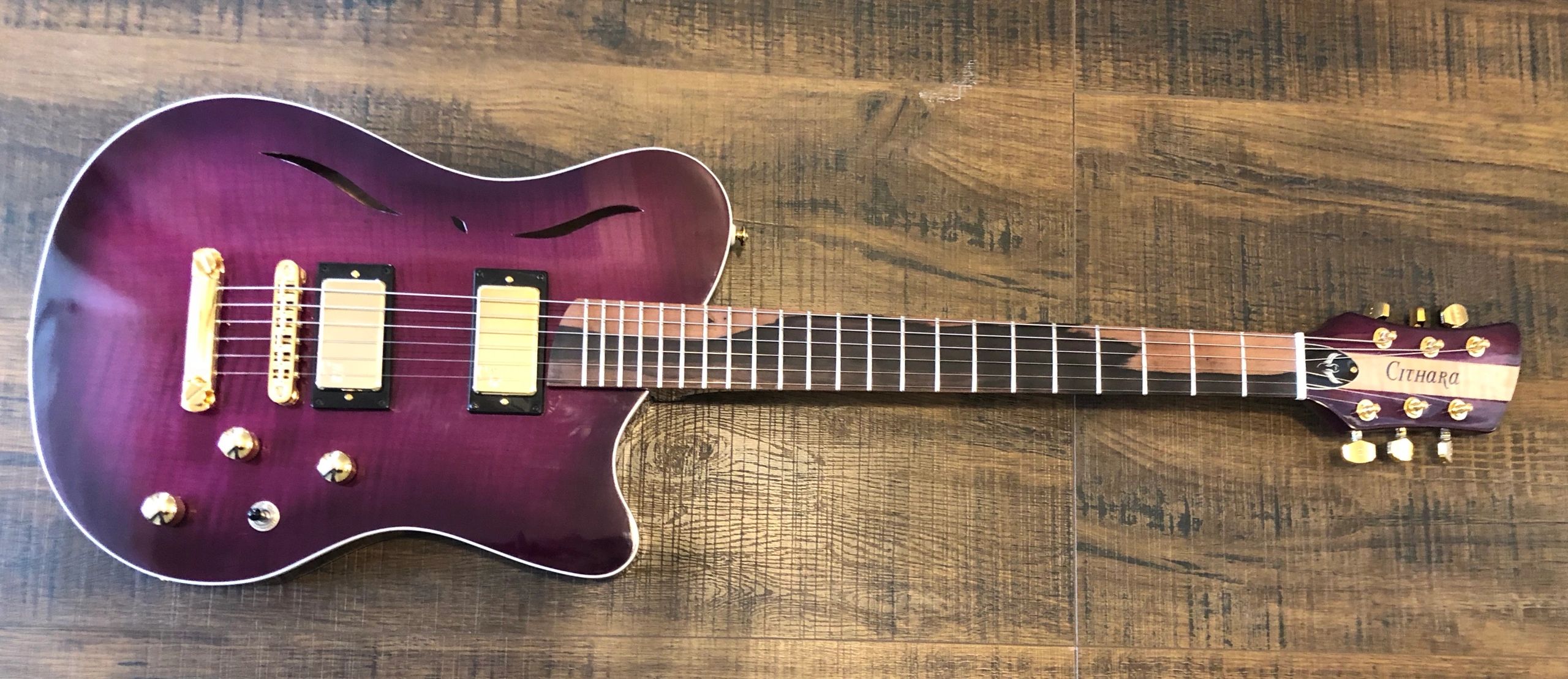 Cithara Guitars' Aphrodite electric guitar with a maple hollow-body and curly maple top.
