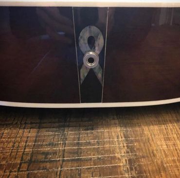 Custom mother of pearl breast cancer flag inlay on back of dreadnought acoustic guitar.