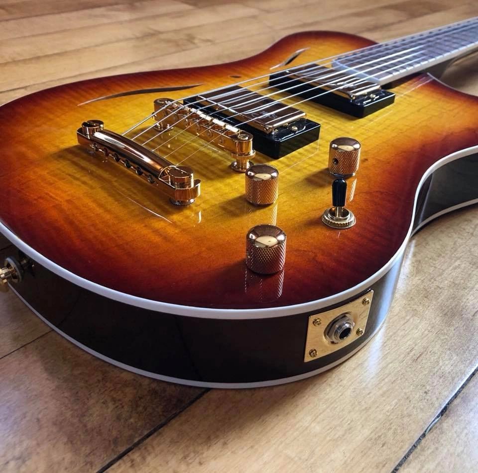 Cithara Guitars' standard hollow-body guitar with a curly maple top, and custom amber burst finish.