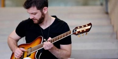 Ontario musician Patrick James Clark with his standard hollow-body model guitar.