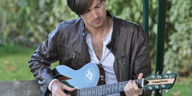 Country musician Ryan Laird playing his custom built Cithara guitar.