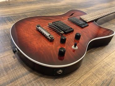 Cithara Guitars Hades model electric guitar with mat black hardware and custom hades redburst.