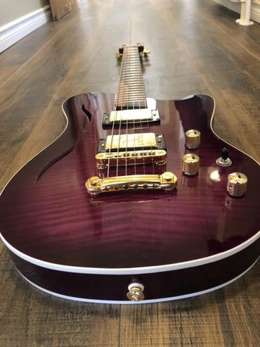 Cithara Guitars' Aphrodite hollow-body guitar with gold hardware.