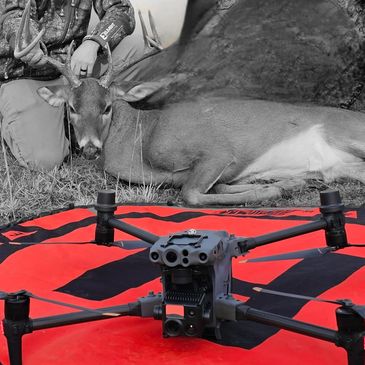 Drone in front of a hunted deer and hunter.