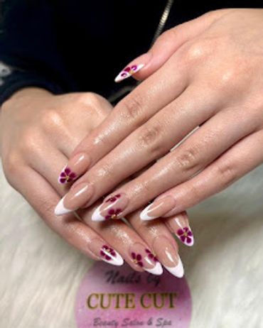 Elegant hands with floral nail art and classic French tip manicure
