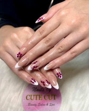 French tip almond nails with burgundy floral nail art — Cute Cut Beauty Salon & Spa, Zinj Bahrain