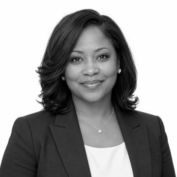Professional black and white headshot of a smiling woman.