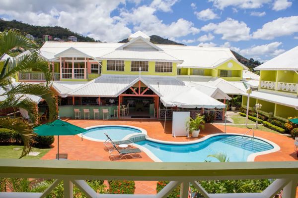 Resort pool area with lounge chairs and umbrellas.