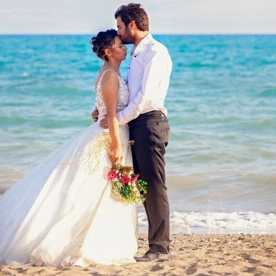 Bride and groom embracing on the beach.