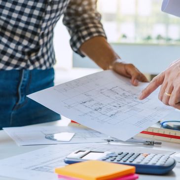 Two people reviewing architectural plans together.
