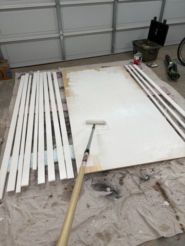 Before - Painting custom closet shelves before they are cut. Sterling Ridge