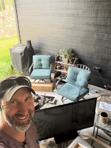 adam taylor the handyman hanging a tv in alden bridge