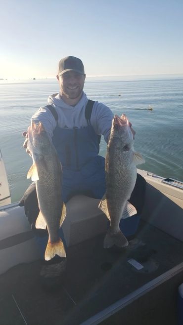 Captain Alex with 2 nice walleye!