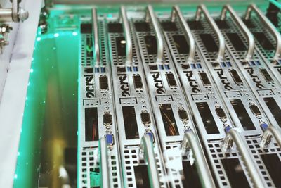 Close-up of server hardware with green lighting.