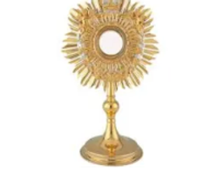 Golden ornate religious monstrance with intricate sunburst design.