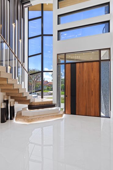 oversize custom wood pivot door. accent wood wall