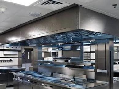 Modern commercial kitchen with stainless steel appliances.