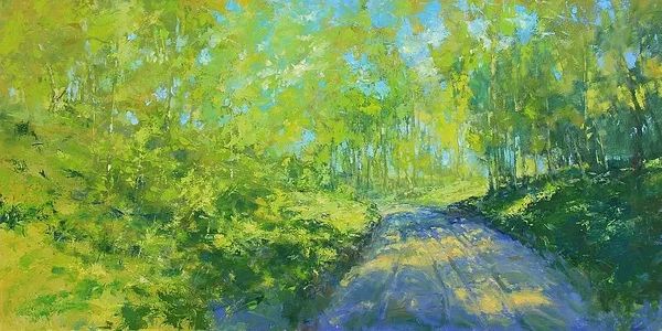 sunny road through trees crossed with shadows