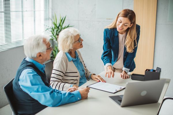 Insurance advisor assisting senior couple