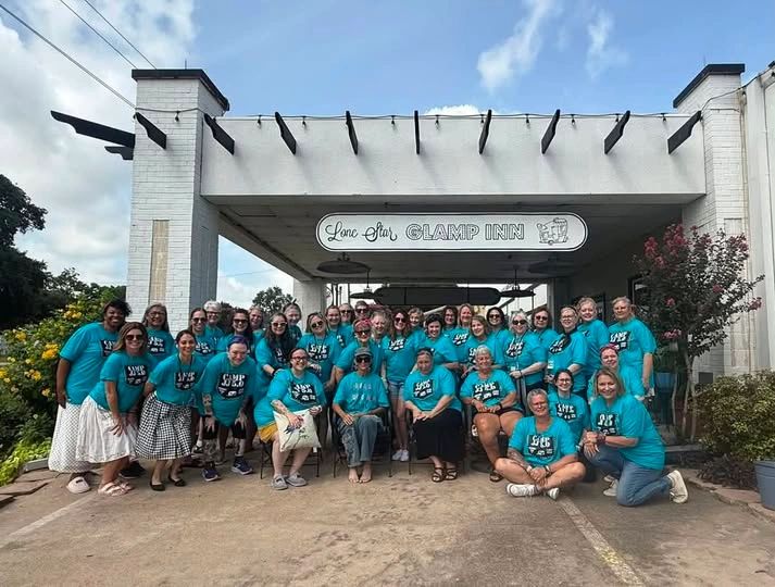 Group of women in matching blue shirts at Lone Star Glamp Inn.