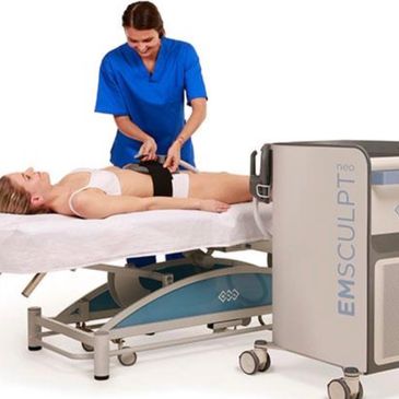 A woman receiving EMSCULPT body contouring treatment from a professional.