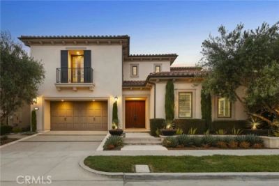Modern two-story house with warm exterior lighting and a double garage.