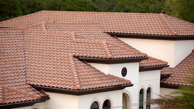 Mediterranean-style house roof with red clay tiles and multiple gables.
