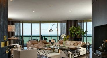 Luxurious living room with ocean view and modern decor.