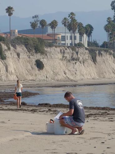 Two Grad student scientists perform sandy beach research on the UC Santa Barbara campus.