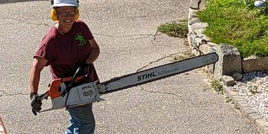 large chainsaw  tree trimming and removal
tree services   person with chainsaw
