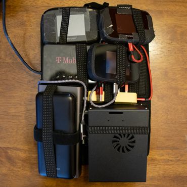 Jetson Nano, two batteries, usb hub, elgato camlink, and 4 modems on a cocoon grid it