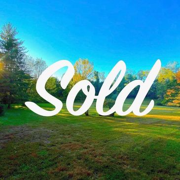 Sunny open field with trees and 'Sold' text overlay.