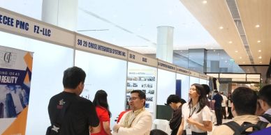 People interacting at a professional booth in a conference hall.