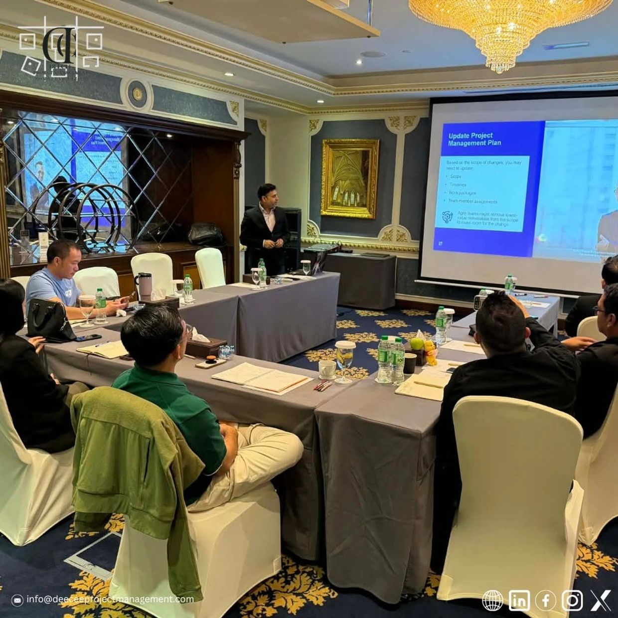 Team attending a project management presentation in a conference room.