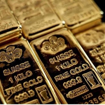Close-up of 1 kilo fine gold bars stamped with purity and weight.