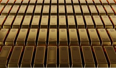 Rows of shiny gold bars labeled with purity and weight.