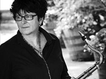 A woman holding a saxophone