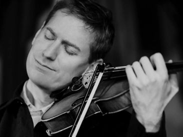 Male violinist playing classical music on violin