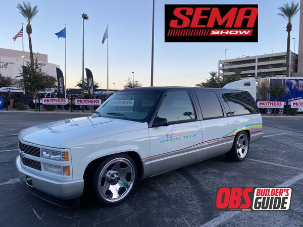 Classic white Chevrolet Suburban with custom rims at SEMA Show.